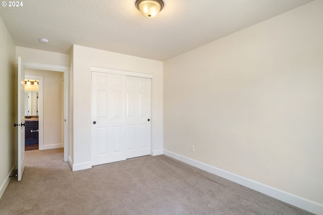 unfurnished bedroom with a closet and carpet flooring