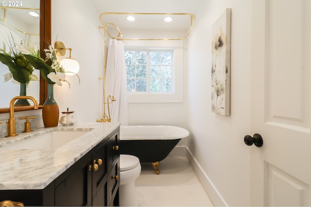 bathroom with a bathing tub, vanity, and toilet