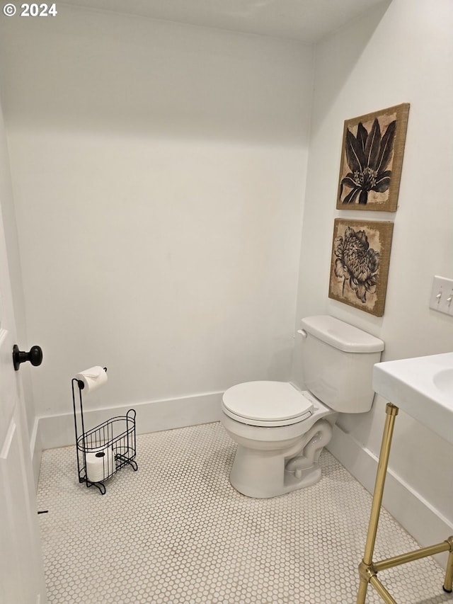 bathroom featuring tile patterned flooring and toilet