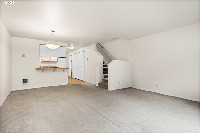 additional living space with heating unit and light colored carpet