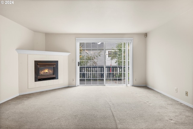 unfurnished living room with a fireplace and carpet flooring