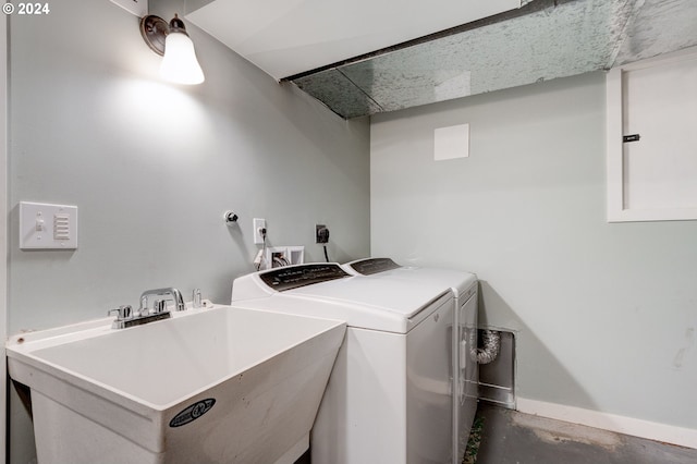 laundry area featuring sink and separate washer and dryer