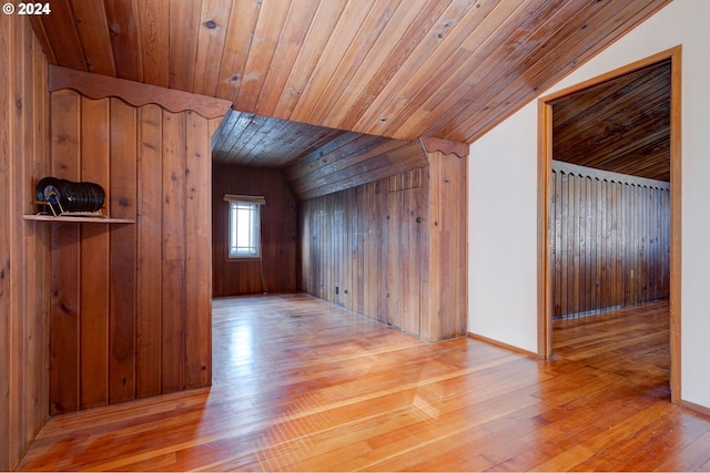 additional living space featuring wood ceiling, lofted ceiling, wooden walls, and light hardwood / wood-style floors