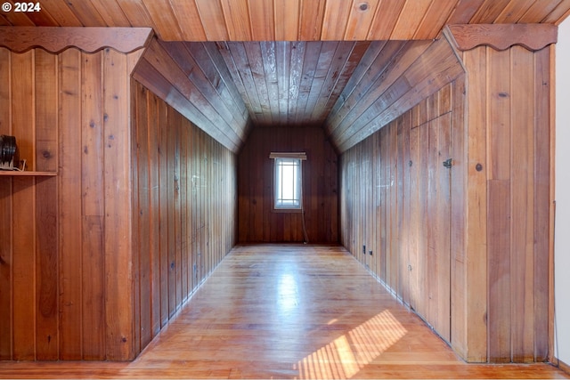 bonus room with wood walls, vaulted ceiling, light hardwood / wood-style floors, and wooden ceiling