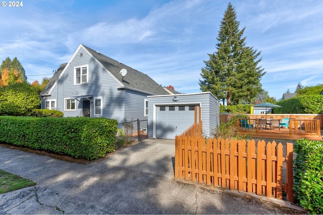 view of side of home with a wooden deck and a garage