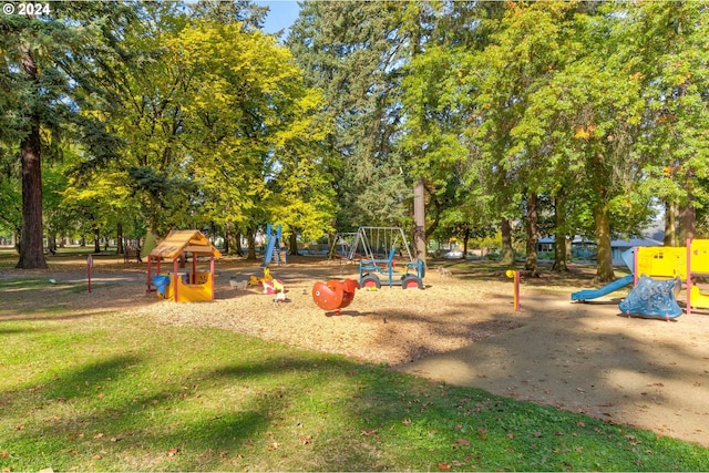 view of playground with a lawn