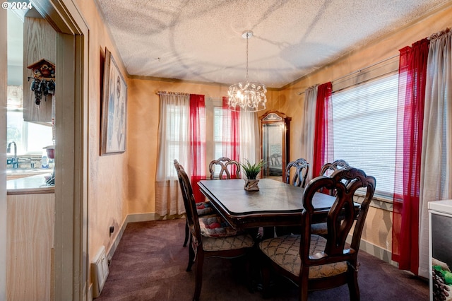 dining room with carpet, a textured ceiling, and a chandelier