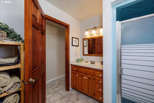 bathroom with vanity and a shower with shower door