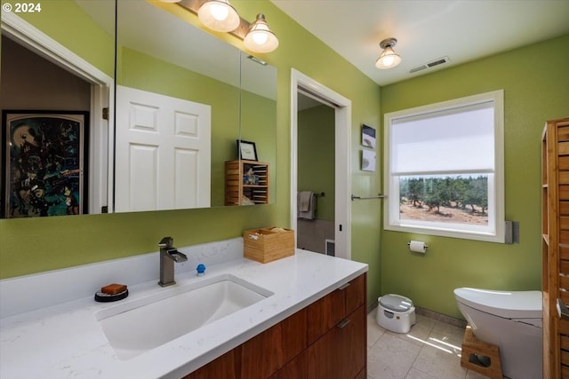 bathroom featuring toilet, tile patterned flooring, and vanity