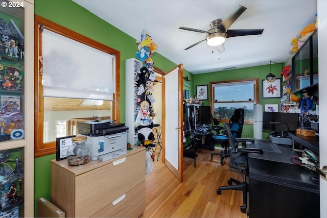 home office featuring light hardwood / wood-style floors, ceiling fan, and a wealth of natural light