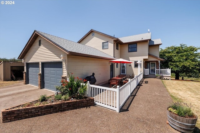 view of front of home featuring a porch and a garage