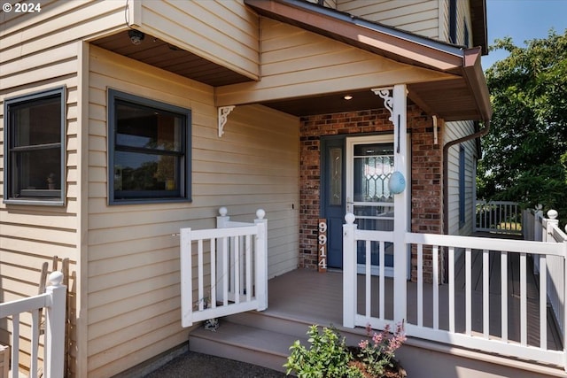 view of exterior entry with covered porch