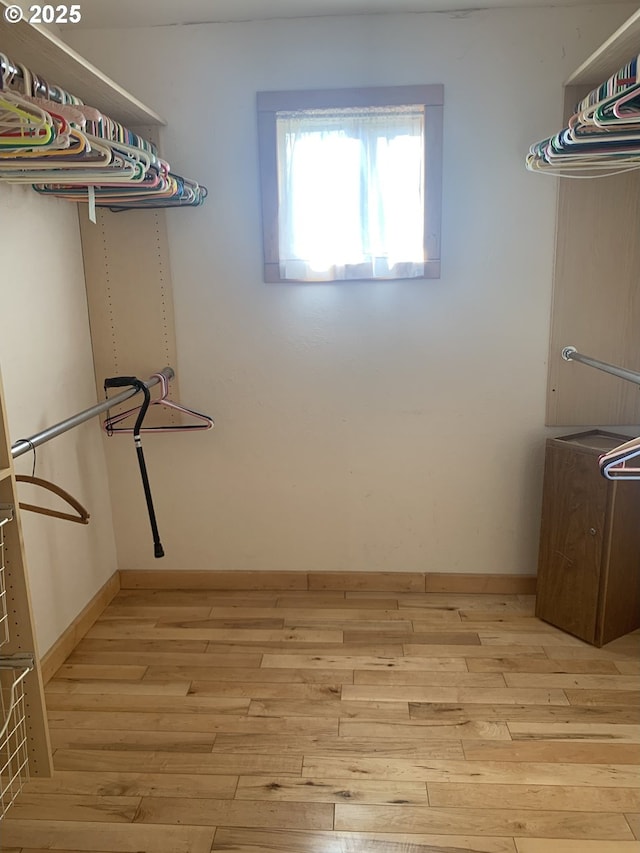 spacious closet featuring light hardwood / wood-style flooring