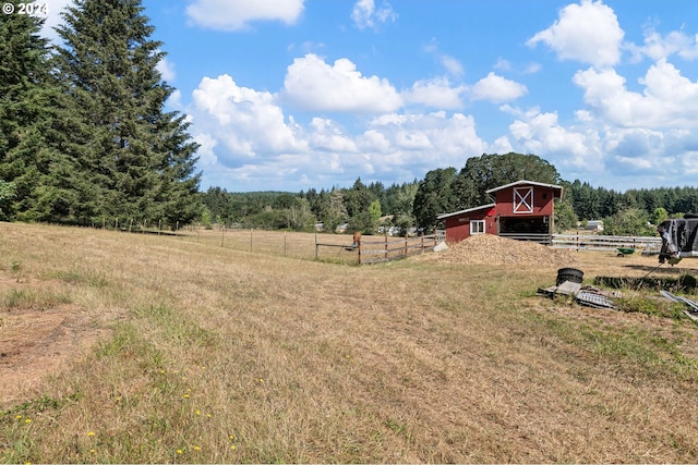 view of yard featuring an outbuilding and a rural view