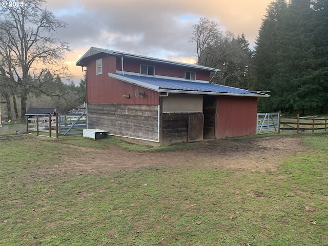 back house at dusk with an outbuilding