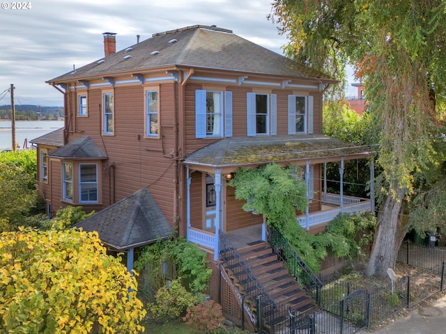 view of front of home featuring a water view and covered porch