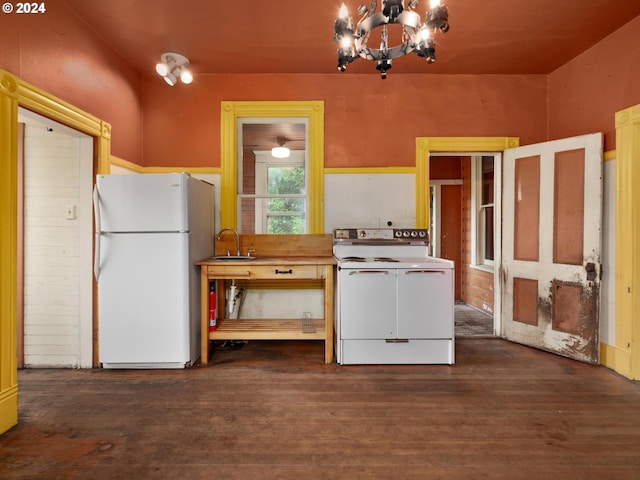 kitchen featuring a notable chandelier, sink, dark hardwood / wood-style flooring, and white appliances