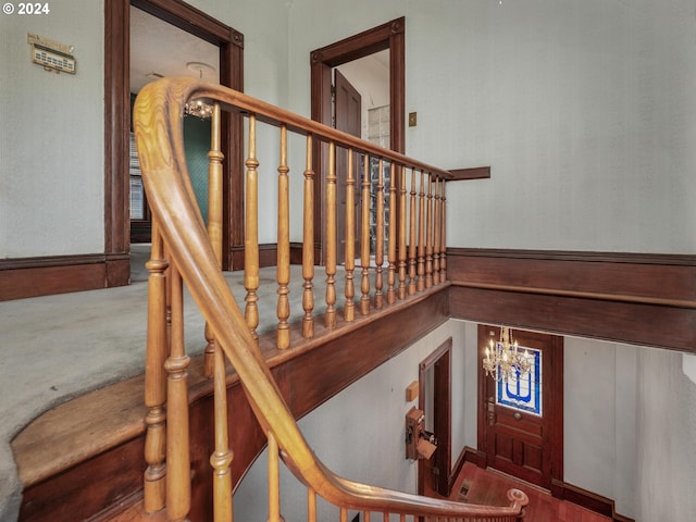 stairs featuring an inviting chandelier