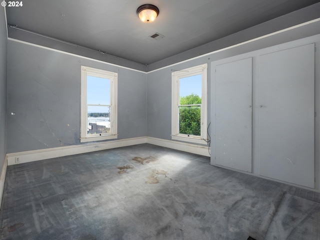 unfurnished bedroom with a closet and carpet flooring