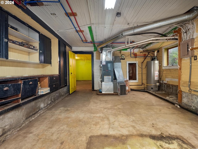 basement with water heater, heating unit, and electric panel