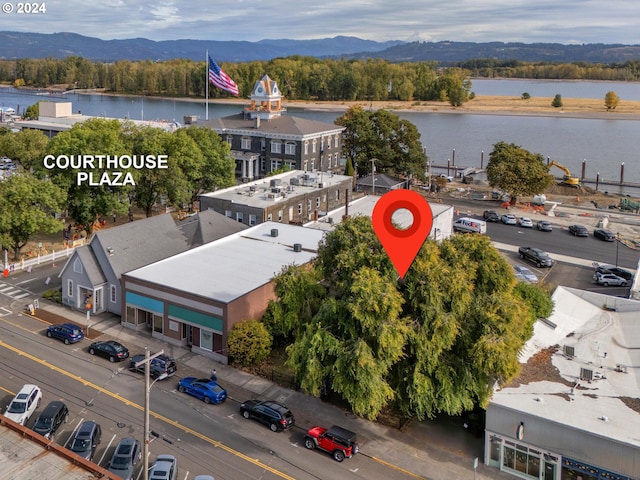 birds eye view of property with a water and mountain view