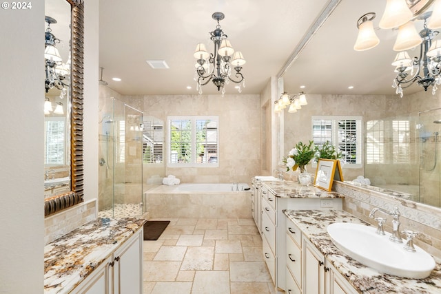 bathroom with vanity, plus walk in shower, and a chandelier