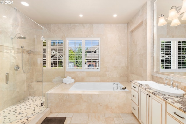 bathroom featuring vanity, tile walls, and plus walk in shower