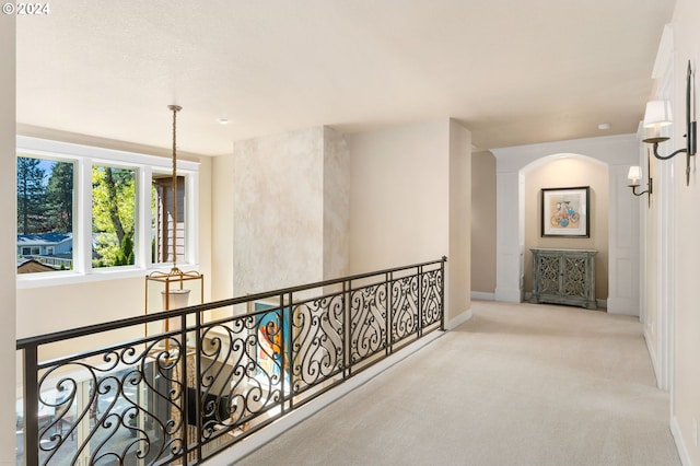 hallway with light colored carpet