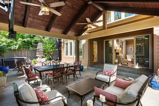 view of patio with outdoor lounge area, ceiling fan, and a hot tub