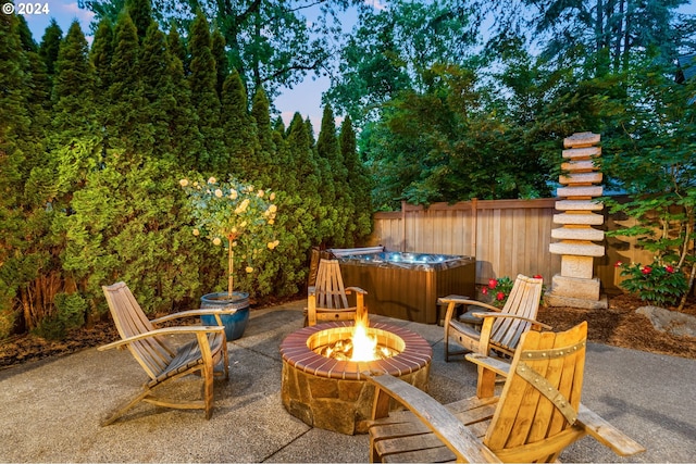 view of patio featuring a hot tub and a fire pit