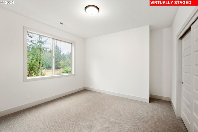 unfurnished bedroom with a closet and carpet floors