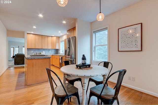 dining space with light hardwood / wood-style flooring