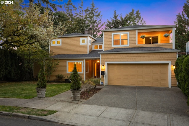 view of front of house featuring a yard and a garage