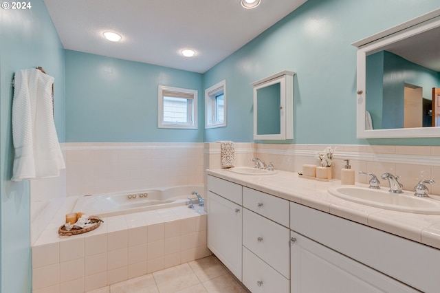 bathroom with vanity, tiled bath, and tile patterned floors