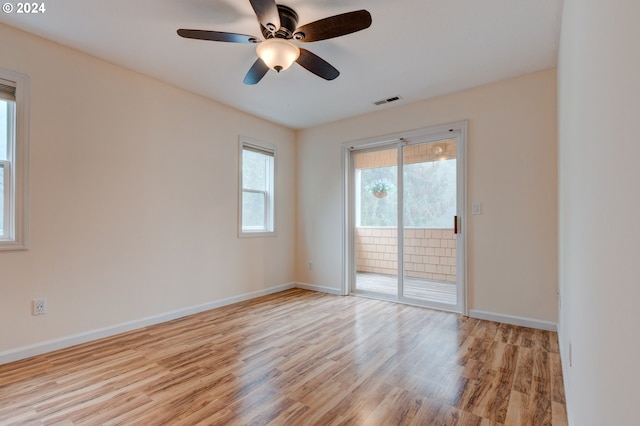 spare room featuring light hardwood / wood-style flooring and ceiling fan