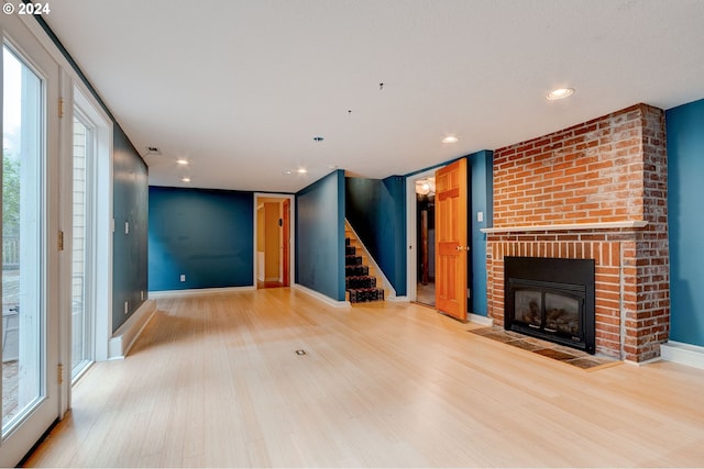 unfurnished living room featuring light hardwood / wood-style flooring and a fireplace