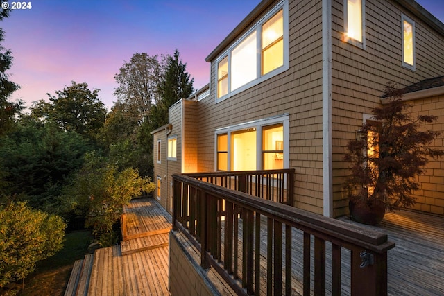 property exterior at dusk with a deck