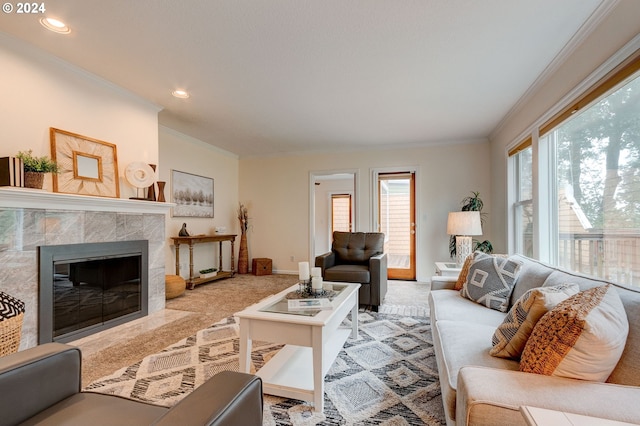 living room featuring ornamental molding, light carpet, and a tiled fireplace