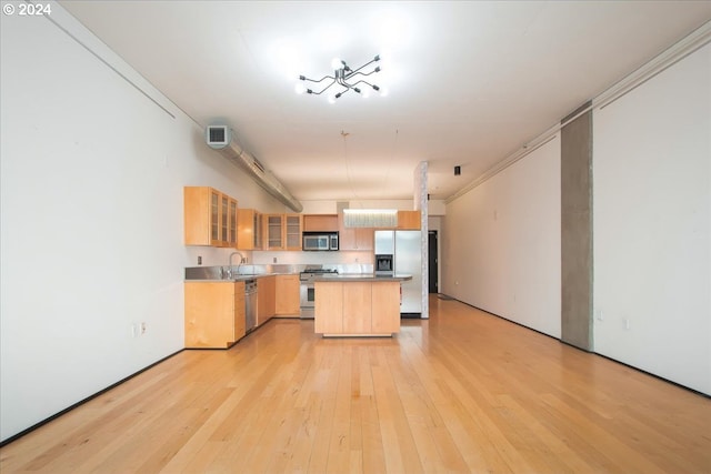 kitchen with light brown cabinets, stainless steel appliances, light wood-type flooring, and ornamental molding