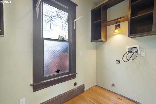 washroom with hookup for a washing machine, light hardwood / wood-style flooring, and hookup for an electric dryer