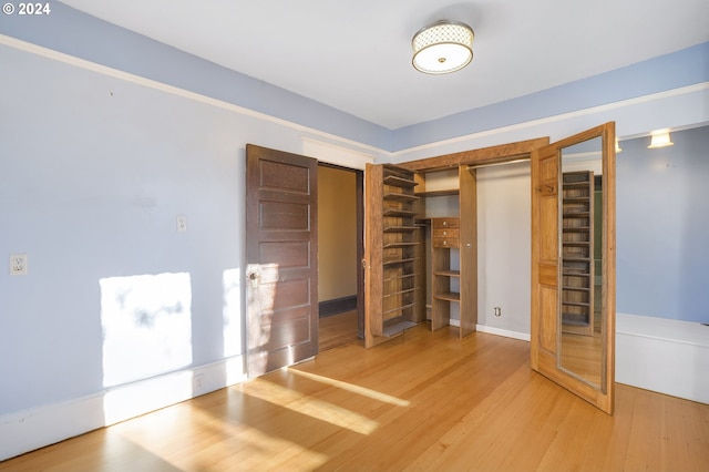 unfurnished bedroom with hardwood / wood-style flooring