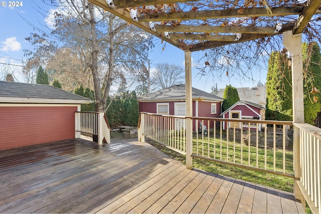 wooden terrace with an outbuilding and a pergola