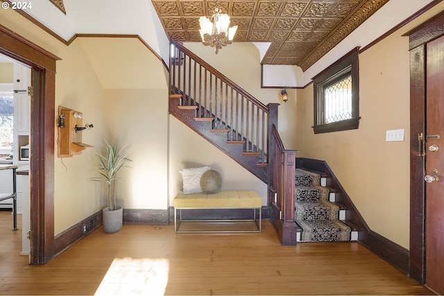 interior space featuring plenty of natural light, wood-type flooring, and a notable chandelier