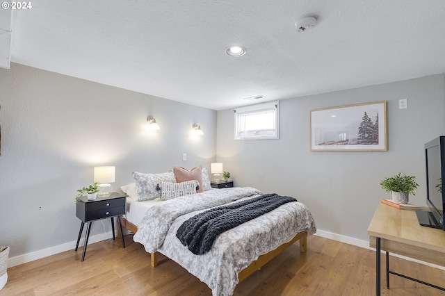 bedroom with hardwood / wood-style flooring