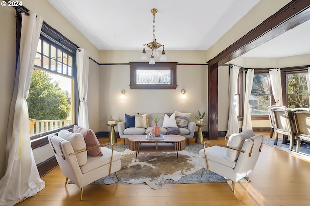 living room with a notable chandelier and light hardwood / wood-style floors