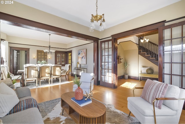 living room with a chandelier and light hardwood / wood-style floors