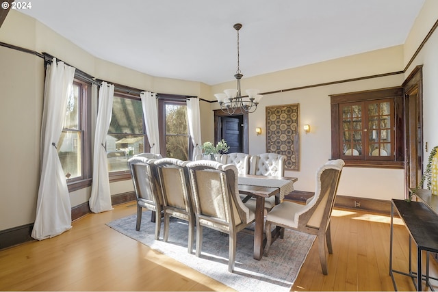 dining space featuring a chandelier and light hardwood / wood-style floors