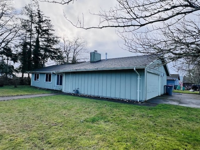 exterior space with a yard and a garage