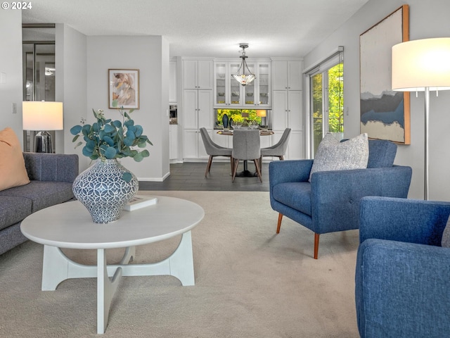 carpeted living room with a textured ceiling