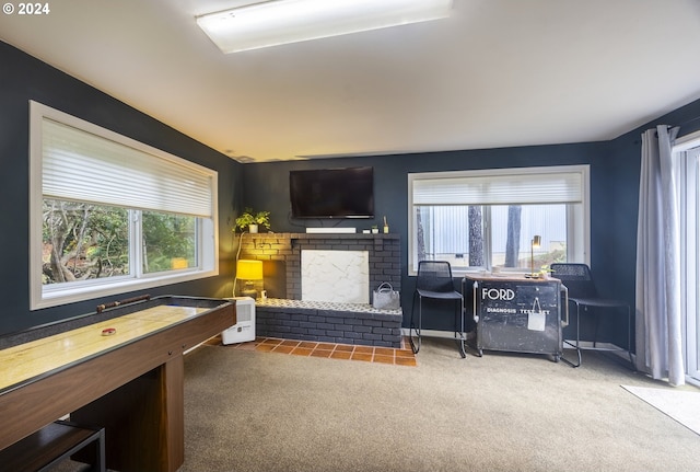 game room featuring a fireplace and carpet floors